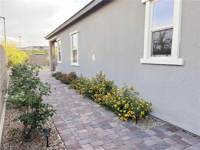 12565 Huckleberry Oak Ave, Las Vegas, NV 89138 - view of side of home with stucco siding and a patio
