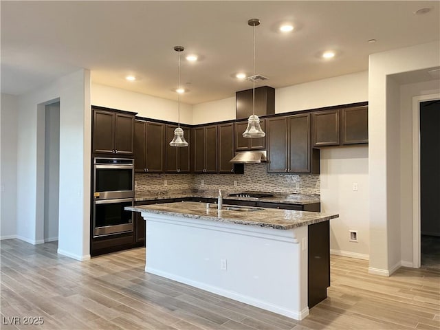 12565 Huckleberry Oak Ave, Las Vegas, NV 89138 - kitchen with double oven, dark brown cabinets, stone counters, backsplash, and recessed lighting