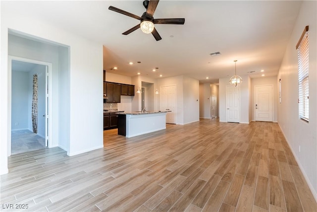 12565 Huckleberry Oak Ave, Las Vegas, NV 89138 - unfurnished living room featuring light wood-style floors, recessed lighting, baseboards, a ceiling fan, and a sink