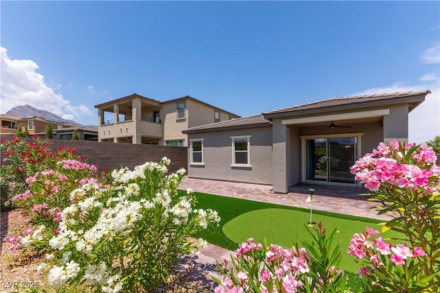 12565 Huckleberry Oak Ave, Las Vegas, NV 89138 - back of house with a patio, ceiling fan, stucco siding, and an area to practice putting