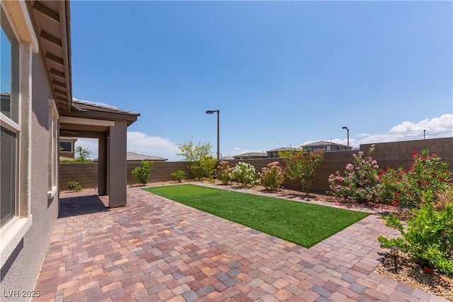 12565 Huckleberry Oak Ave, Las Vegas, NV 89138 - fenced backyard with a patio area