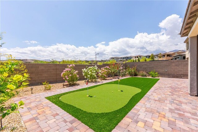 12565 Huckleberry Oak Ave, Las Vegas, NV 89138 - fenced backyard featuring a putting green and a patio