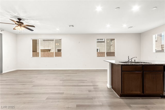 7189 Ashcroft St, North Las Vegas, NV 89084 - kitchen with a sink, ceiling fan, light wood finished floors, baseboards, and recessed lighting