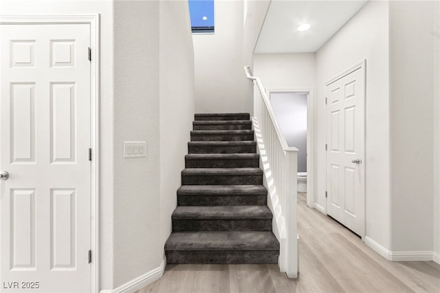 7189 Ashcroft St, North Las Vegas, NV 89084 - staircase with wood finished floors and baseboards
