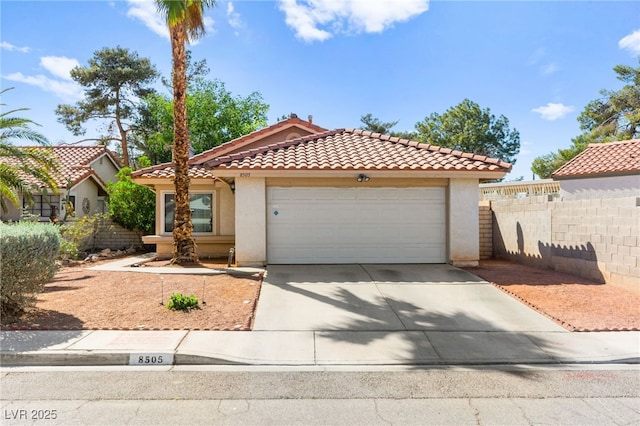 8505 Lansdale Rd, Las Vegas, NV 89123 - mediterranean / spanish home with stucco siding, concrete driveway, a tiled roof, and a garage