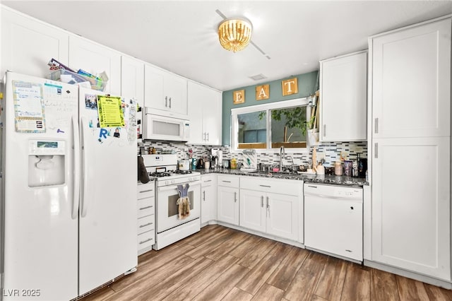 8505 Lansdale Rd, Las Vegas, NV 89123 - kitchen with white appliances, a sink, backsplash, and white cabinetry