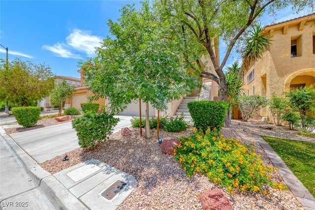 4044 Villeroy Ave, Las Vegas, NV 89141 - view of front of home with stucco siding, a garage, driveway, and stairway
