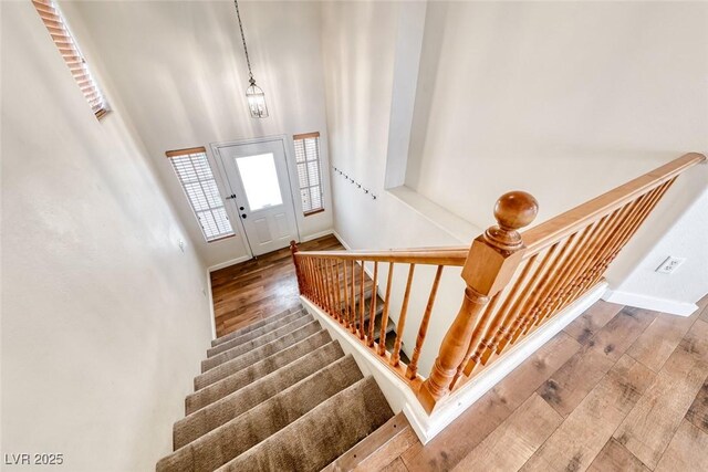 4044 Villeroy Ave, Las Vegas, NV 89141 - entryway with hardwood / wood-style floors, stairs, baseboards, and a high ceiling