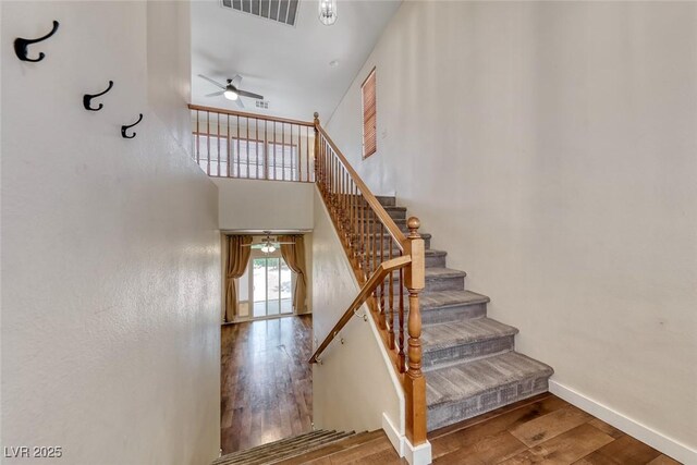 4044 Villeroy Ave, Las Vegas, NV 89141 - stairway featuring ceiling fan, wood finished floors, and baseboards