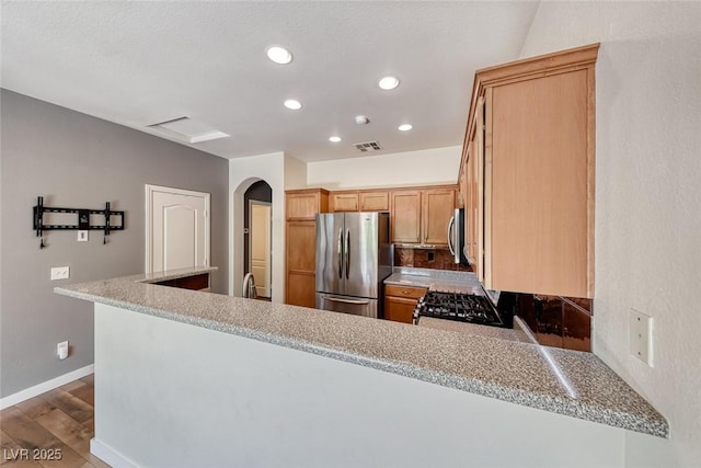 4044 Villeroy Ave, Las Vegas, NV 89141 - kitchen featuring stainless steel appliances, recessed lighting, wood finished floors, a peninsula, and light countertops