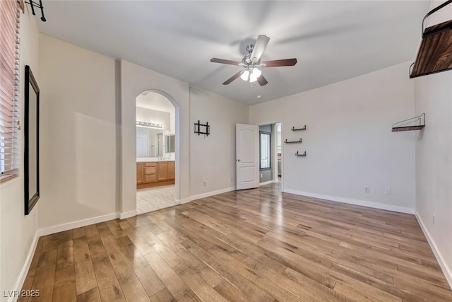 4044 Villeroy Ave, Las Vegas, NV 89141 - spare room with a ceiling fan, arched walkways, light wood-style floors, and baseboards