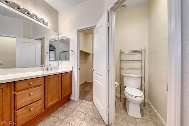 4044 Villeroy Ave, Las Vegas, NV 89141 - bathroom with vanity, tile patterned floors, toilet, baseboards, and a closet