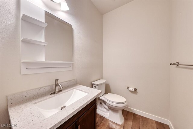 4044 Villeroy Ave, Las Vegas, NV 89141 - half bathroom with toilet, wood finished floors, vanity, and baseboards