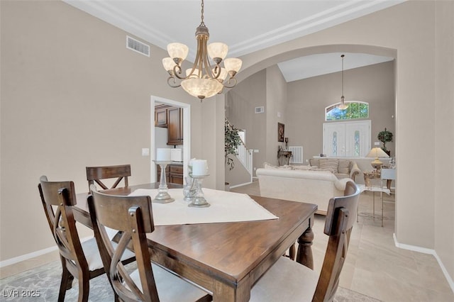 9017 Cotton Rose Way, Las Vegas, NV 89134 - dining space featuring arched walkways, a chandelier, baseboards, and high vaulted ceiling