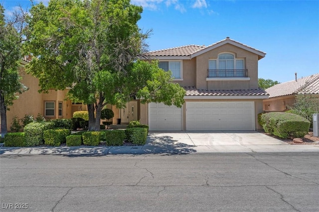 9017 Cotton Rose Way, Las Vegas, NV 89134 - view of front of house featuring concrete driveway, a tile roof, an attached garage, and stucco siding