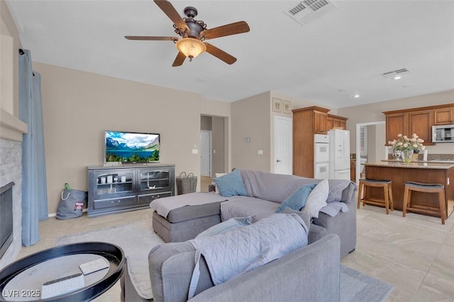 9017 Cotton Rose Way, Las Vegas, NV 89134 - living room featuring a ceiling fan, a fireplace, recessed lighting, and light tile patterned floors