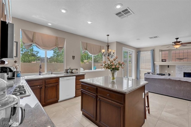 9017 Cotton Rose Way, Las Vegas, NV 89134 - kitchen featuring white dishwasher, a chandelier, open floor plan, recessed lighting, and light stone counters