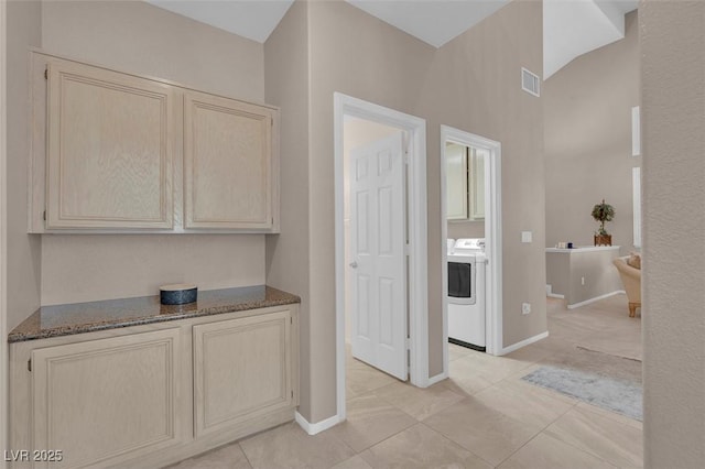 9017 Cotton Rose Way, Las Vegas, NV 89134 - hallway featuring washer / dryer, light tile patterned floors, vaulted ceiling, and baseboards
