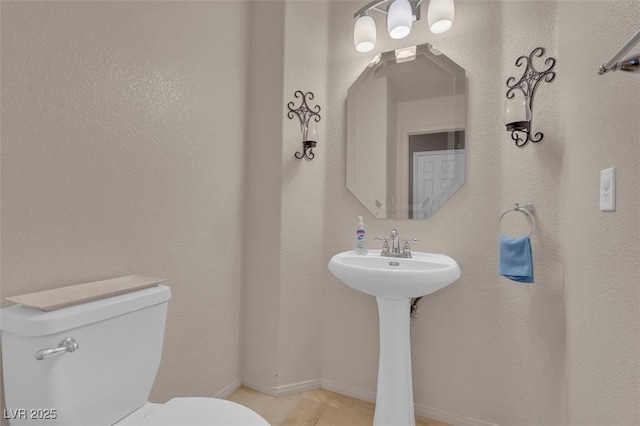 9017 Cotton Rose Way, Las Vegas, NV 89134 - bathroom featuring toilet, baseboards, a sink, and tile patterned flooring