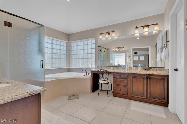 9017 Cotton Rose Way, Las Vegas, NV 89134 - bathroom featuring vanity, a stall shower, a garden tub, and tile patterned floors