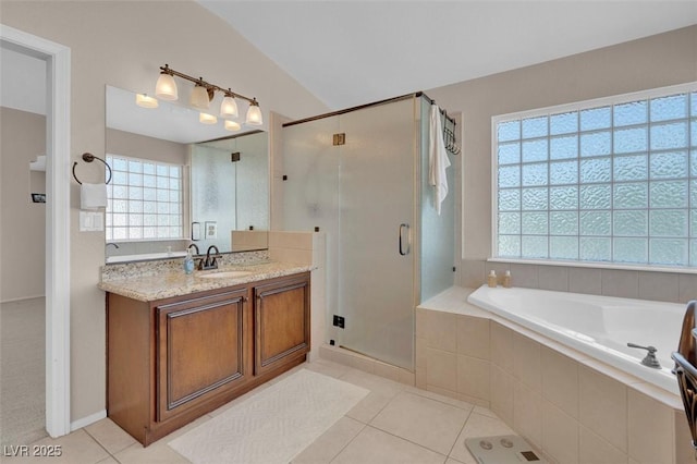 9017 Cotton Rose Way, Las Vegas, NV 89134 - bathroom featuring vanity, healthy amount of natural light, a bath, tile patterned floors, and lofted ceiling