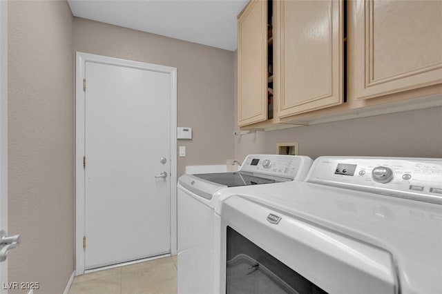 9017 Cotton Rose Way, Las Vegas, NV 89134 - laundry area featuring separate washer and dryer, cabinet space, and light tile patterned floors
