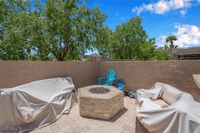 9017 Cotton Rose Way, Las Vegas, NV 89134 - fenced backyard featuring an outdoor living space with a fire pit and a patio