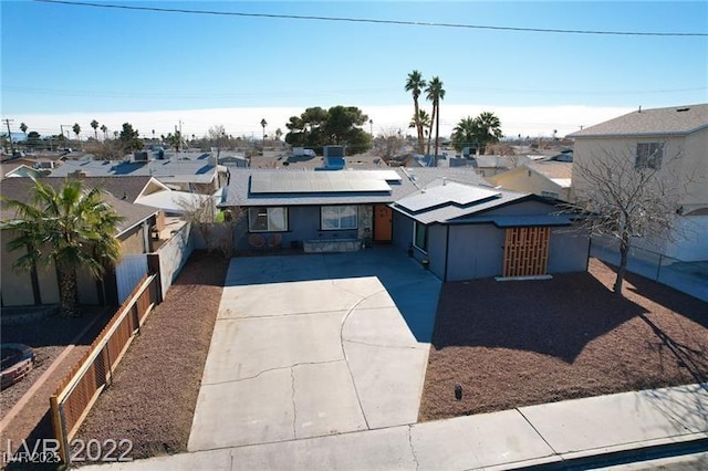 5817 Rae Dr, Las Vegas, NV 89108 - view of front facade with concrete driveway, solar panels, and a residential view