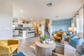 7915 Pandora Sky St Unit 402, North Las Vegas, NV 89084 - living room featuring stairs, light wood-type flooring, and recessed lighting