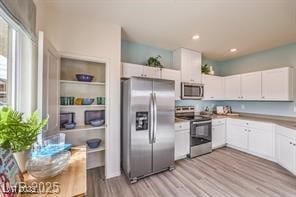 7915 Pandora Sky St Unit 402, North Las Vegas, NV 89084 - kitchen featuring stainless steel appliances, white cabinetry, light wood-style floors, light countertops, and recessed lighting