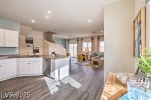 7915 Pandora Sky St Unit 402, North Las Vegas, NV 89084 - kitchen with white cabinetry, dark wood-style flooring, a peninsula, recessed lighting, and open floor plan