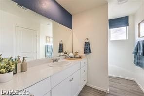 7915 Pandora Sky St Unit 402, North Las Vegas, NV 89084 - bathroom featuring vanity, wood finished floors, and baseboards