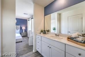 7915 Pandora Sky St Unit 402, North Las Vegas, NV 89084 - ensuite bathroom with vanity and wood finished floors