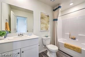 7915 Pandora Sky St Unit 402, North Las Vegas, NV 89084 - full bath with vanity, toilet, shower / bath combo with shower curtain, and wood finished floors