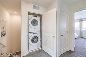7915 Pandora Sky St Unit 402, North Las Vegas, NV 89084 - laundry room featuring estacked washer and dryer and dark carpet