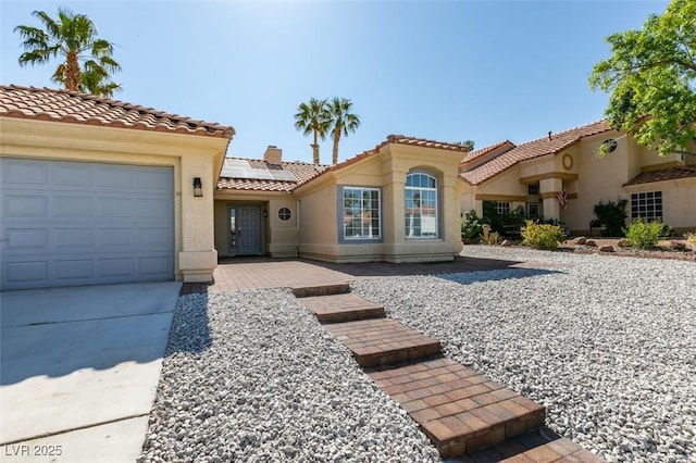 8150 Beaverbrook Way, Las Vegas, NV 89123 - mediterranean / spanish-style house with solar panels, a tiled roof, stucco siding, an attached garage, and concrete driveway