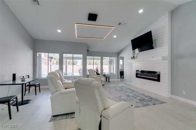 8150 Beaverbrook Way, Las Vegas, NV 89123 - living area with baseboards, vaulted ceiling, light wood-style floors, recessed lighting, and a large fireplace