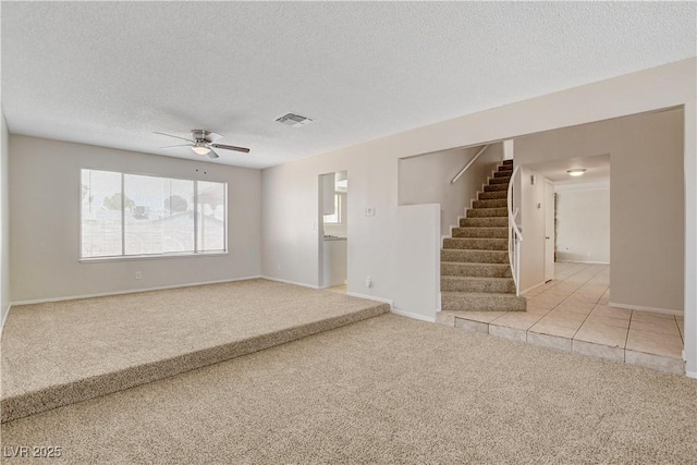 7004 Powderhorn Cir, Las Vegas, NV 89128 - unfurnished living room featuring carpet floors, stairs, ceiling fan, a textured ceiling, and baseboards