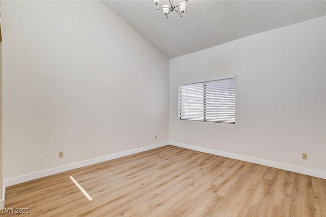 8233 Willeta Ave, Las Vegas, NV 89145 - unfurnished room featuring lofted ceiling, wood finished floors, a textured ceiling, baseboards, and a chandelier
