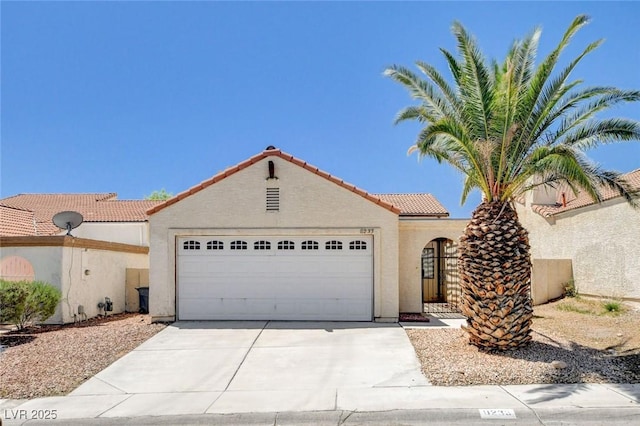 8233 Willeta Ave, Las Vegas, NV 89145 - mediterranean / spanish-style home with an attached garage, stucco siding, a tile roof, and concrete driveway