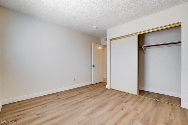 8233 Willeta Ave, Las Vegas, NV 89145 - unfurnished bedroom featuring wood finished floors, a closet, a textured ceiling, and baseboards