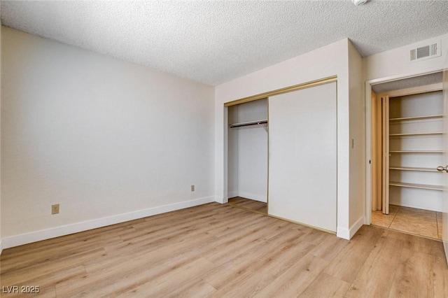 8233 Willeta Ave, Las Vegas, NV 89145 - unfurnished bedroom featuring light wood-style floors, a closet, a textured ceiling, and baseboards