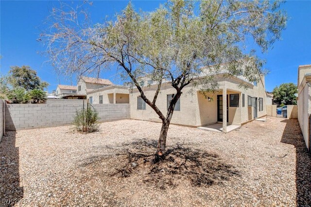 8233 Willeta Ave, Las Vegas, NV 89145 - back of house featuring stucco siding, a fenced backyard, and a patio area