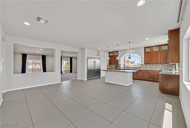 6507 Creekside Cellars Ct, Las Vegas, NV 89139 - kitchen with plenty of natural light, light tile patterned flooring, built in fridge, tasteful backsplash, and recessed lighting