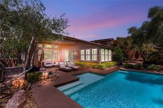 900 Cantura Mills Rd, Henderson, NV 89052 - back of property featuring a patio area, an outdoor pool, outdoor lounge area, and stucco siding