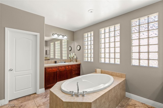 900 Cantura Mills Rd, Henderson, NV 89052 - bathroom featuring vanity, a bath, baseboards, and plenty of natural light