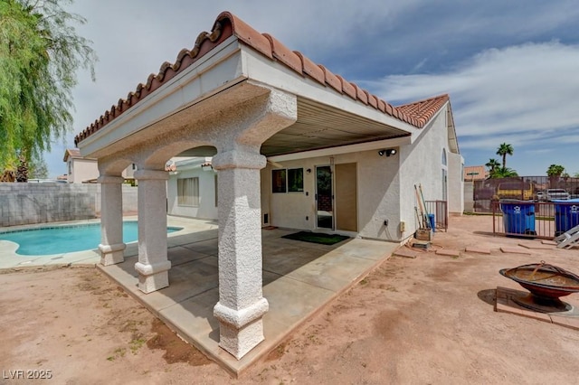 1523 Silver Point Ave, Las Vegas, NV 89123 - back of house with a tiled roof, stucco siding, a fire pit, and a fenced backyard