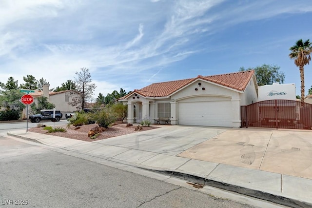 1523 Silver Point Ave, Las Vegas, NV 89123 - mediterranean / spanish house with a tile roof, stucco siding, a gate, a garage, and driveway