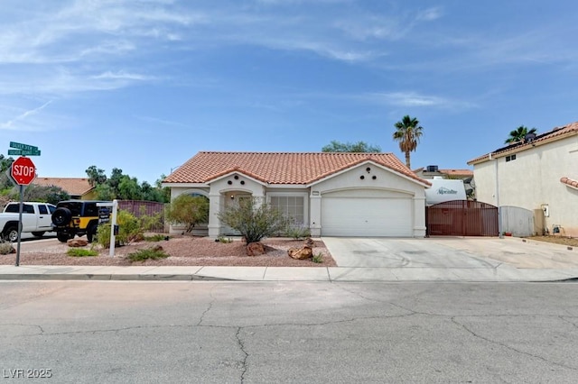 1523 Silver Point Ave, Las Vegas, NV 89123 - mediterranean / spanish home with a gate, a tile roof, an attached garage, concrete driveway, and stucco siding