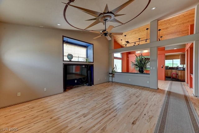 1523 Silver Point Ave, Las Vegas, NV 89123 - unfurnished living room featuring wood finished floors, a ceiling fan, recessed lighting, and vaulted ceiling